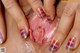 A close up of a woman's hand with a manicure on her fingernails.