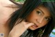 A woman with long black hair is posing for a picture.