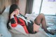 A woman laying on a bed talking on a cell phone.