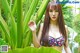 A woman in a bikini standing next to a pond.