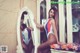 A woman in a bathing suit standing in front of a mirror.