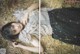 A woman laying on a pile of hay.