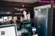 A woman standing behind a counter in a restaurant.